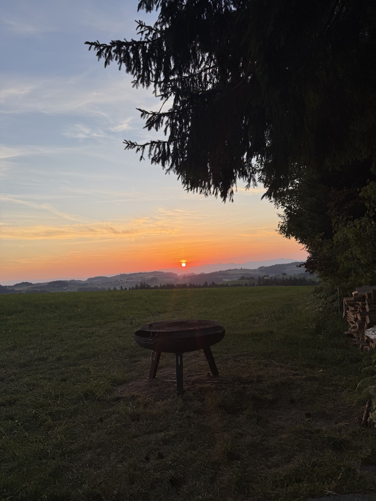 Feuerschale auf der Wiese im Sonnenuntergang